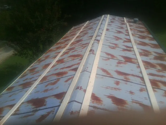 Rusted metal roof panels with new wood purlins before replacement — Storm Damage Roof Repair in Georgiana by Roofing Brothers