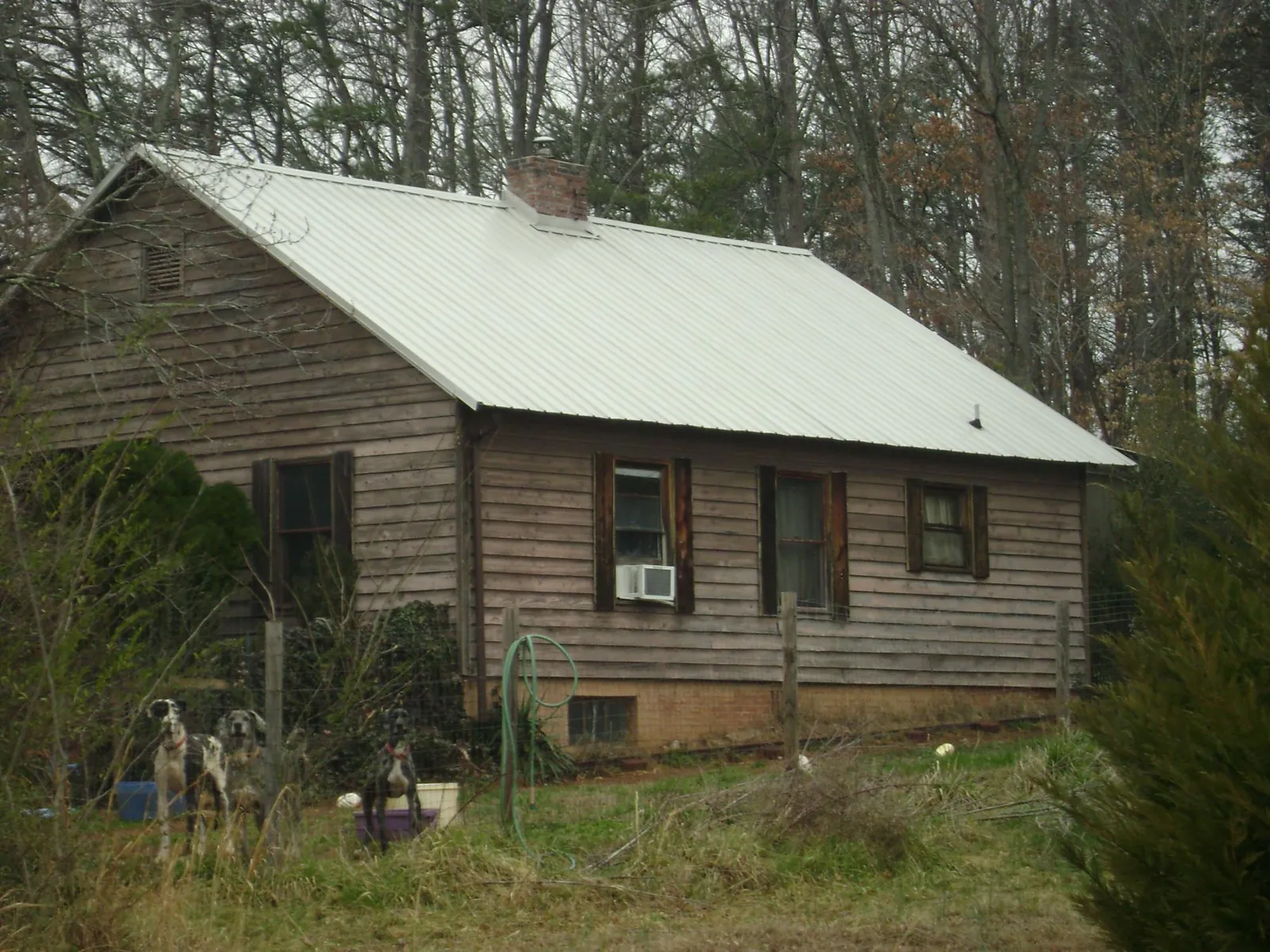 White metal roof on an old wood sided farmhouse, from a Metal Roof Installation job in Georgiana